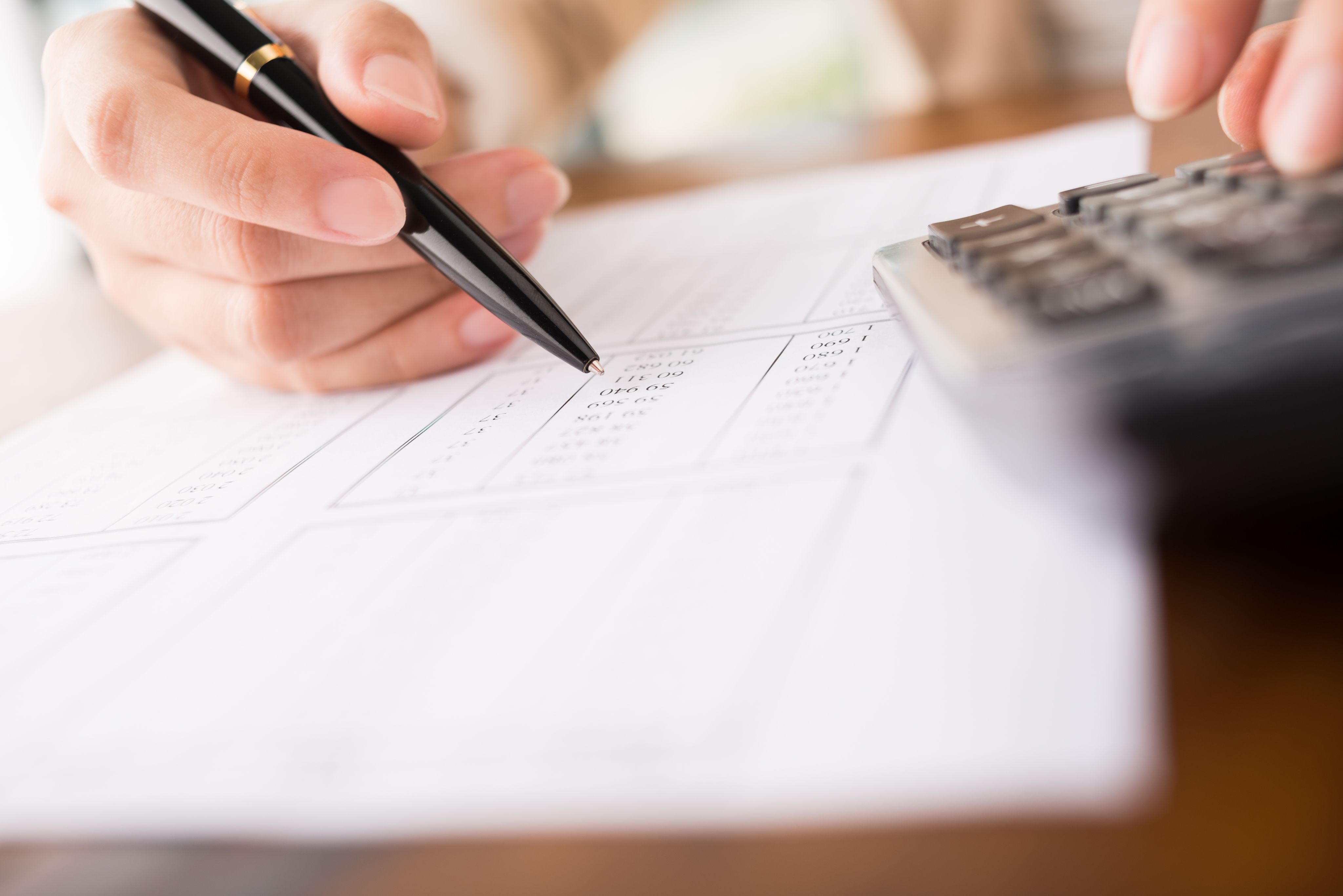 close-up of accountant working on report