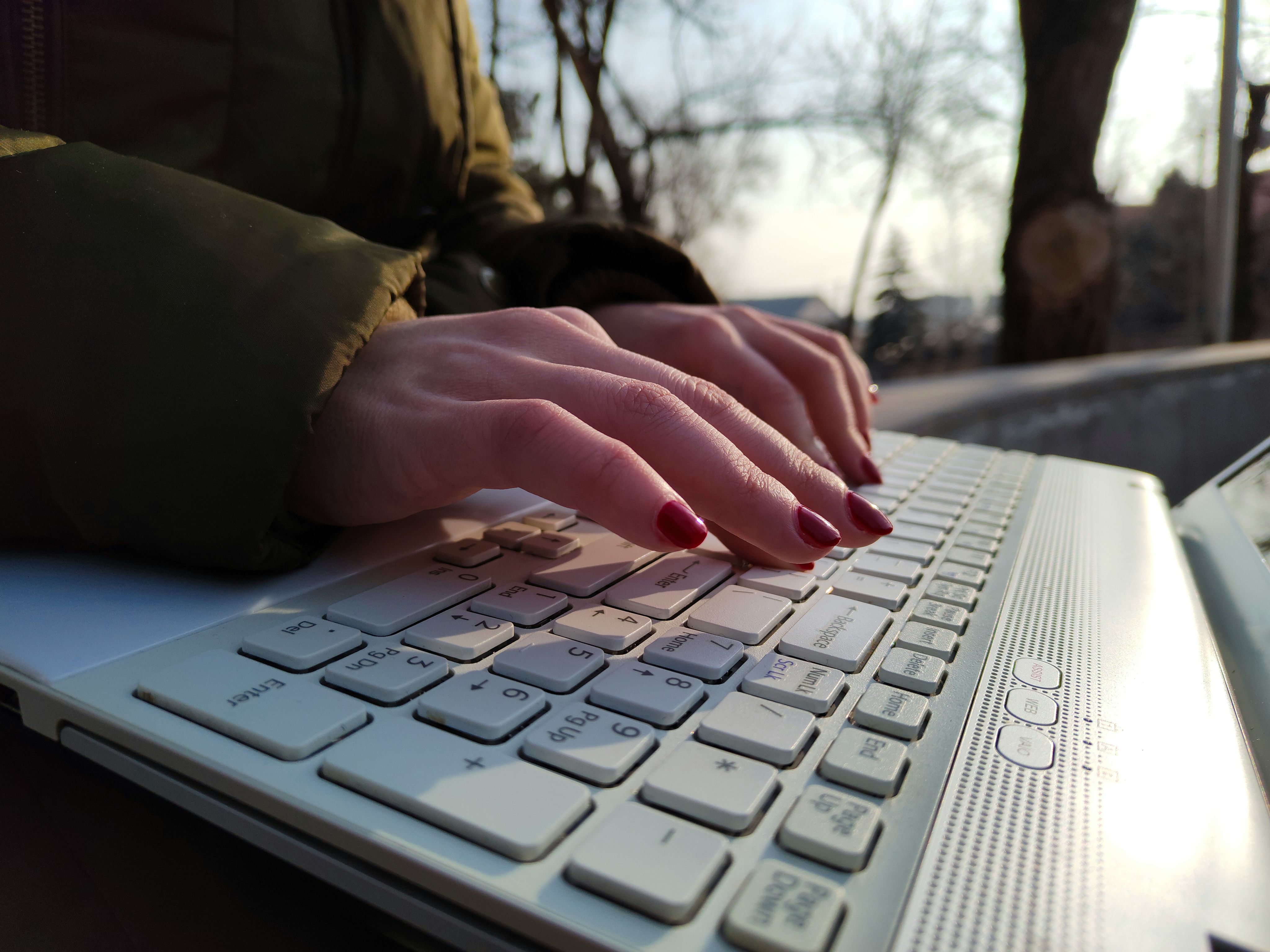 a close up of a person typing on a laptop